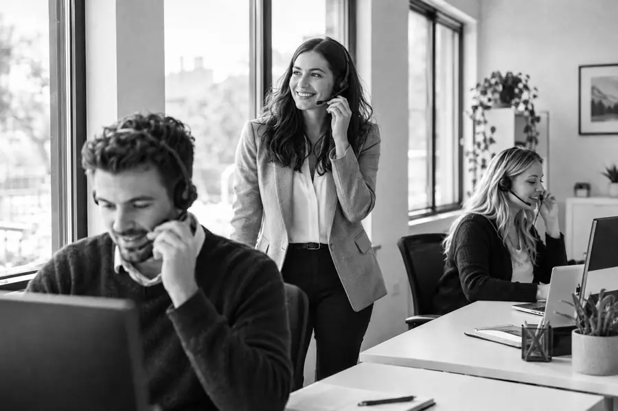 Insurance agents on calls in a bright office.